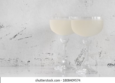 Two glasses of White Lady Cocktail on white background