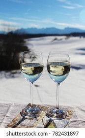 Two Glasses Of White Wine On The Balcony, Dreamlike Winter Landscape With Mountains In The Background, Happy Moment