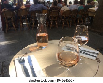 Two Glasses Of Rosé Wine And A Carafe At A French Brasserie In Paris.