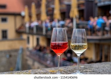 Two Glasses Of Wine  On The Fence Of  Old  Bridge Across The Main River In Wurzburg, Germany.