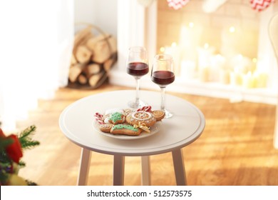 Two Glasses Of Wine And Plate Of Christmas Cookies On Table In Room