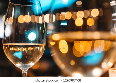 Two glasses of wine stand on the festive table