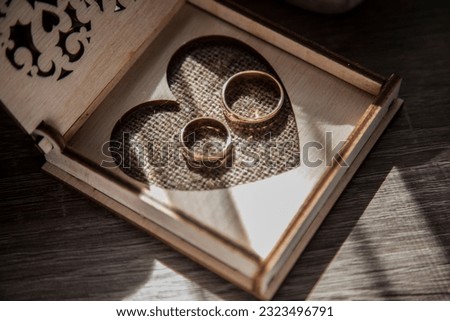 
Two gleaming rings intertwine, symbolizing eternal love. Against a backdrop of delicate lace, they radiate promise, unity, and commitment. A simple yet powerful image capturing the essence of marriag