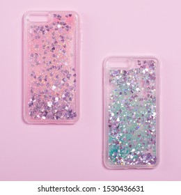 Two Glitter Liquid Phone Cases Isolated On A Pink Background. Clear Phone Case Mockup Back View