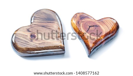 two glossy laked wooden hearts isolated on white