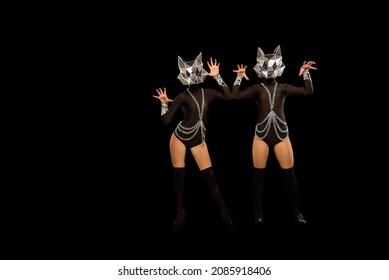 Two Go-go Variety Show Dancers In Wolf Masks On Black