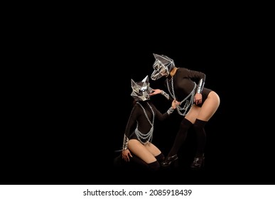 Two Go-go Variety Show Dancers In Wolf Masks On Black