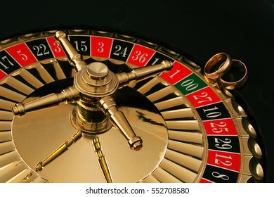 Two gold wedding rings on the roulette wheel - Powered by Shutterstock