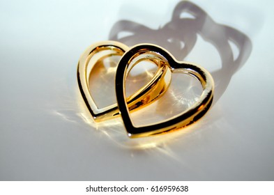 Two golden hearts with shadow 
