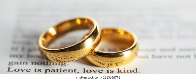 Two golden wedding rings on Holy bible book close up - Powered by Shutterstock