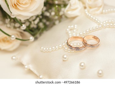 Two Golden Wedding Rings with purls on pillow