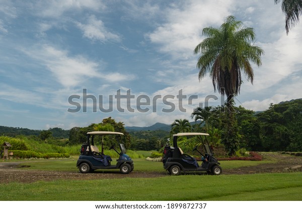 Two golf buggies on a fairway San Buenas golf\
course tropical Costa Rica 