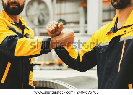 Two good colleagues engineering colleagues bump fist positive energy together show professionalism engineer industrial work successful team : Teamwork and unity concept.