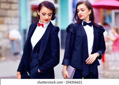 Two Gorgeous Women Posing In Black Suits