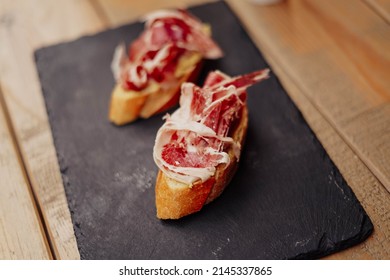 Two gourmet canapes of raw Iberian ham
