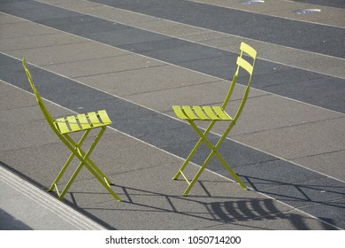 Two Green Chairs Facing Each Other, With No One Sat In Them