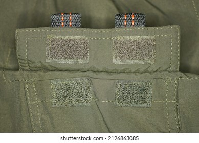 two green velcro on the fabric of the army clothing pocket