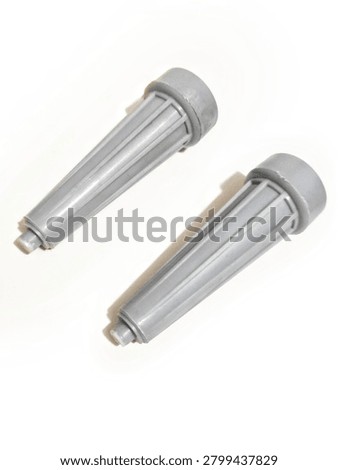 Two grey plastic pulsator rollers for washing machine, side roller agitator parts, washing machine spare parts isolated on white background with  soft shadow. Pair of white plastic side pulsator rollers for automatic washing machine. Agitator part, washing machine component, spare part for repair. Isolated on white background, macro product photography, vertical orientation.
