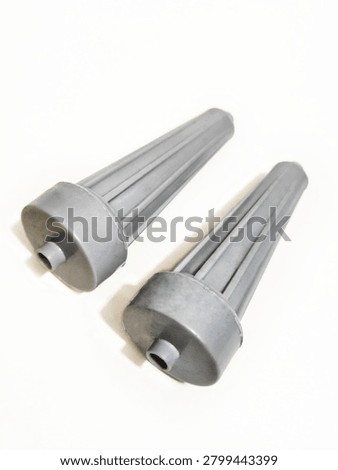 Two grey plastic pulsator rollers for washing machine, side roller agitator parts, washing machine spare parts isolated on white background with soft shadow. Pair of white plastic side pulsator rollers for automatic washing machine. Agitator part, washing machine component, spare part for repair. Isolated on white background, macro product photography, vertical orientation.