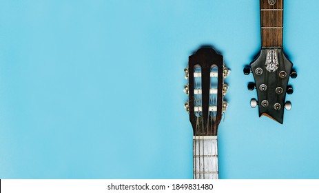 Two Guitars On A Blue Background