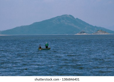 Two Guys Fishing In The Lake 