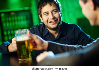 Two Guys Hanging Out In Bar With Mugs Of Beer