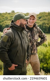 Two guys hunters fishers wearing tactical hunter gear happy meet each other and enjoy nice natural outdoor landscape - Shutterstock ID 2194659601