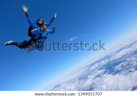 Two guys are jumping a skydiving tandem.