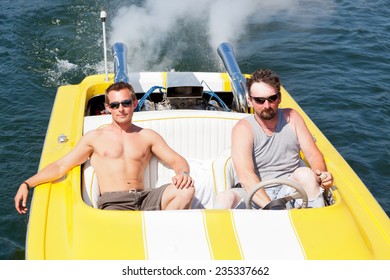 Two Guys In A Yellow And White Speedboat In The Sunshine On Lake Coeur D'Alene, ID.