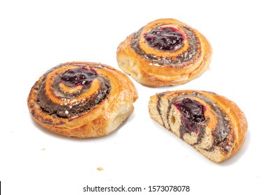 Two and a half Cherry rolls with poppyseeds and yeast doght on a white background