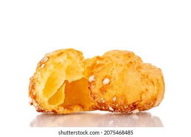 Two halves of a fragrant Chouquette on in a glass dish, close-up, isolated on white.