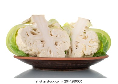 Two Halves Of Fragrant Organic Cauliflower On A Clay Dish, Close-up, Isolated On White.
