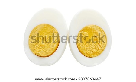 Two halves of a hard boiled egg with yellow yolk and white albumen