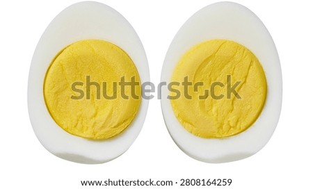 Two halves of a hard boiled egg with yellow yolk and white albumen