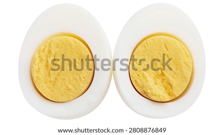 Two halves of a hard boiled egg with yellow yolk and white albumen