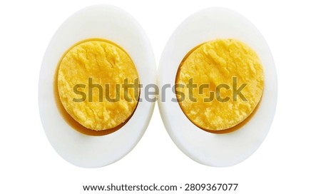 Two halves of a hard boiled egg with yellow yolk and white albumen