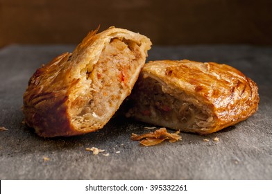 Two halves of a pasty on a grey background. - Shutterstock ID 395332261
