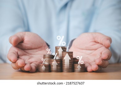 Two hand giving heap of coins money with up arrow and percentage symbol for financial banking increase interest rate or mortgage investment dividend from business growth concept. - Shutterstock ID 2187527637