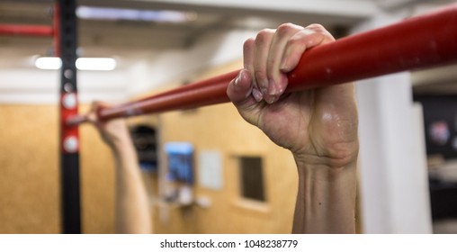 Two Hand On Red Pull Up Bar