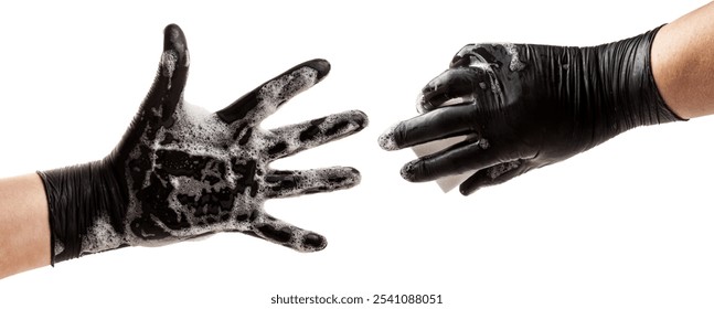 Two hands in black rubber gloves. One hand holds a sponge in the foam, and the other hand holds the foam. The process of washing dishes or cleaning. Isolated on white - Powered by Shutterstock