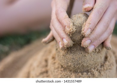 Two hands building the sand. - Powered by Shutterstock