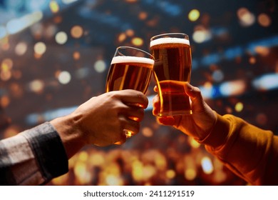 Two hands clinking with mug of cold foamy beer. People celebrating start of Oktoberfest. Selective focus. Blurred. Concept of cheers, toasts, party, celebration, taste, national traditions. - Powered by Shutterstock