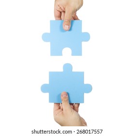 Two Hands Connecting Puzzle Pieces