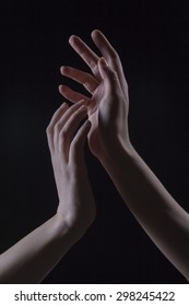 Two hands in the dark