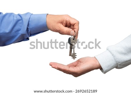 Two hands are exchanging keys, representing a significant moment of acquiring a new house and beginning a fresh chapter.