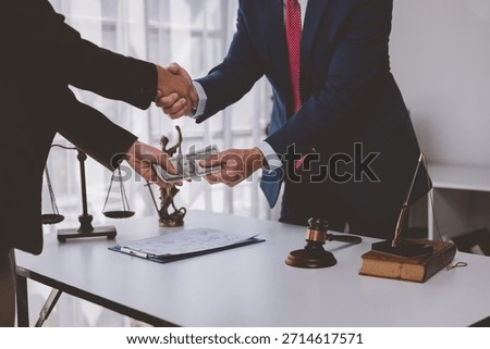 Two hands exchanging money while shaking hands, representing corruption in legal system