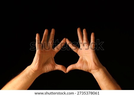 Two Hands Forming a Triangle Shape Against a Dark Background — Symmetrical Close‑Up Highlighting Gesture, Balance, Precision and Expressive Human Form