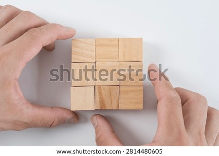 Two hands frame a set of empty wooden cubes, creating a clean visual for business planning, strategy, education, branding, or customizable concept design.
