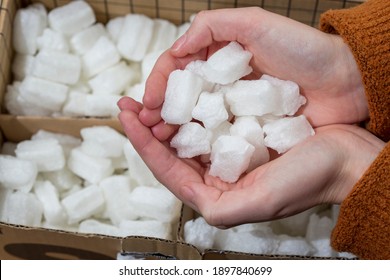 Two Hands Full Of Corn Starch Packaging Which Is Easily Compostible 