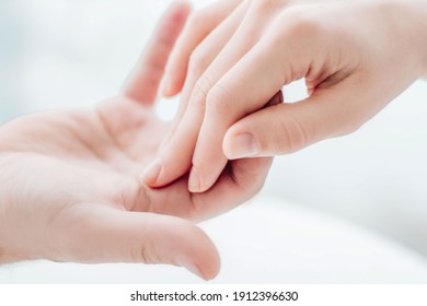 Two hands gently touching each other closeup. Holding hands. Love, skin care, tenderness, relationship, Valentine's day, hands cream, softness, tenderness concept.